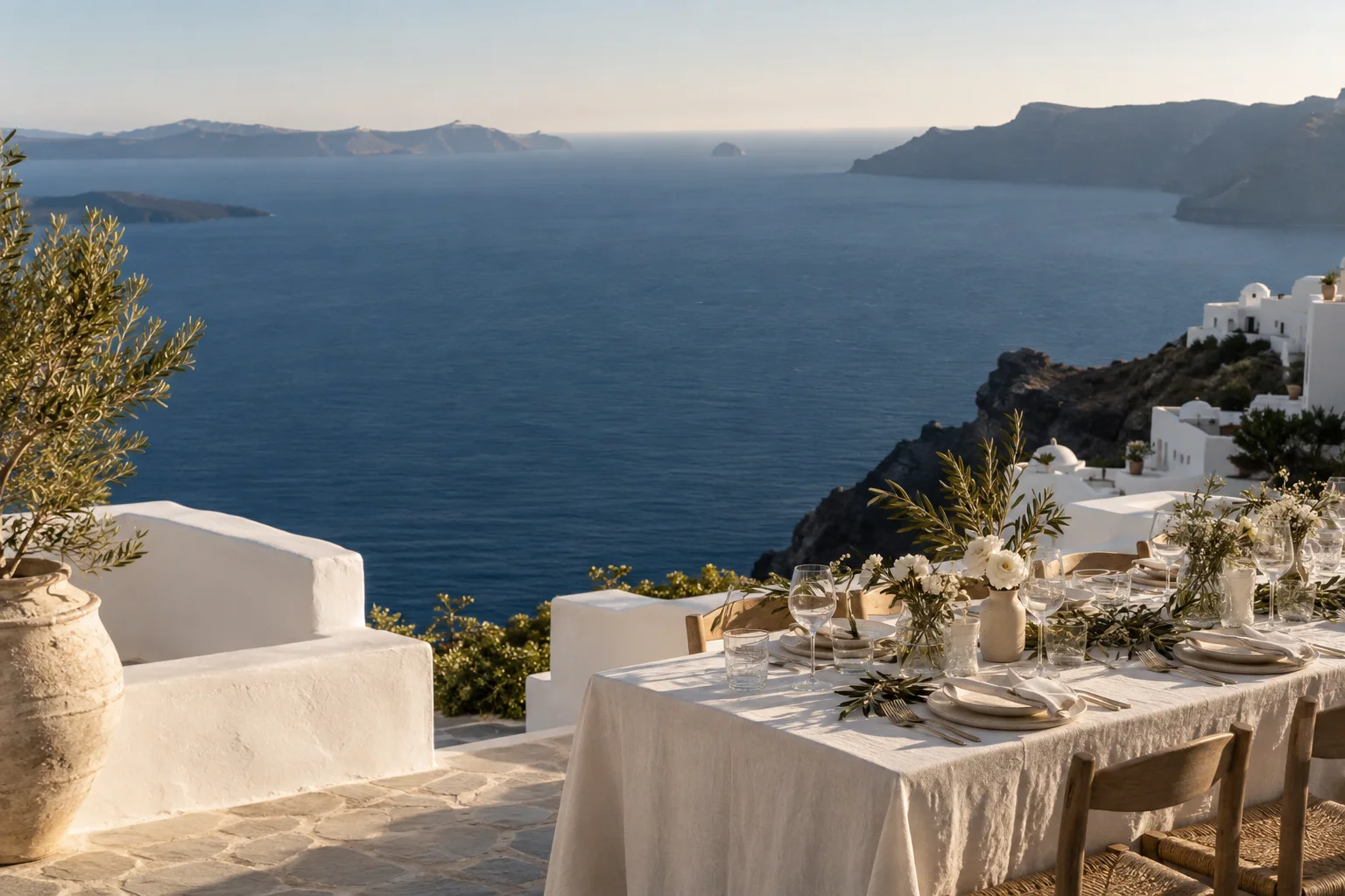 A quiet sunlit terrace looking out across the blue sea.